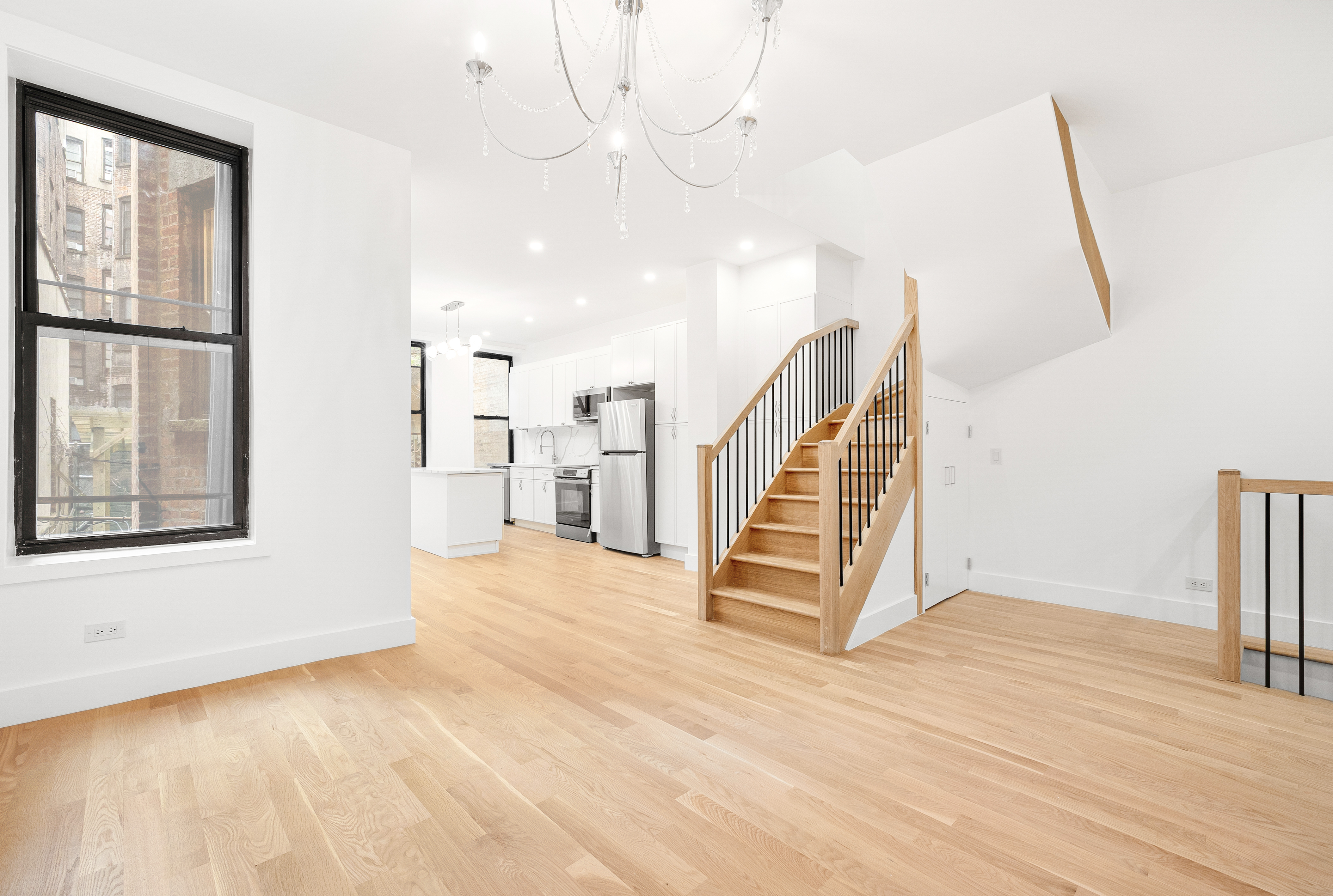 a view of an entryway with wooden floor