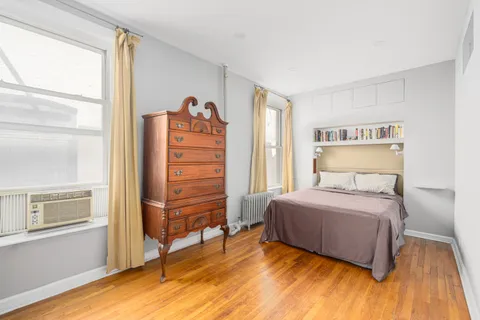 a bedroom with a bed and a dresser