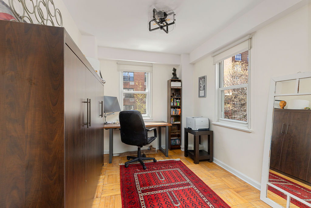 101 West 12th Street, Unit 5V Manhattan, NY 10011 - Photo 14 of 26 a view of a workspace with furniture and a window