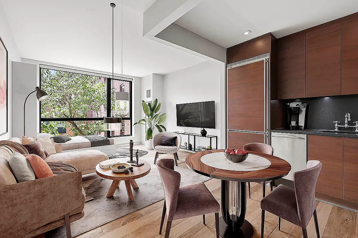 540 West 28th Street, Unit 8A Manhattan, NY 10001 - Photo 1 of 12 a living room with furniture a flat screen tv and a large window