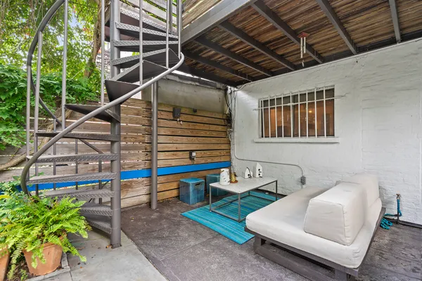 a balcony with furniture and a potted plant