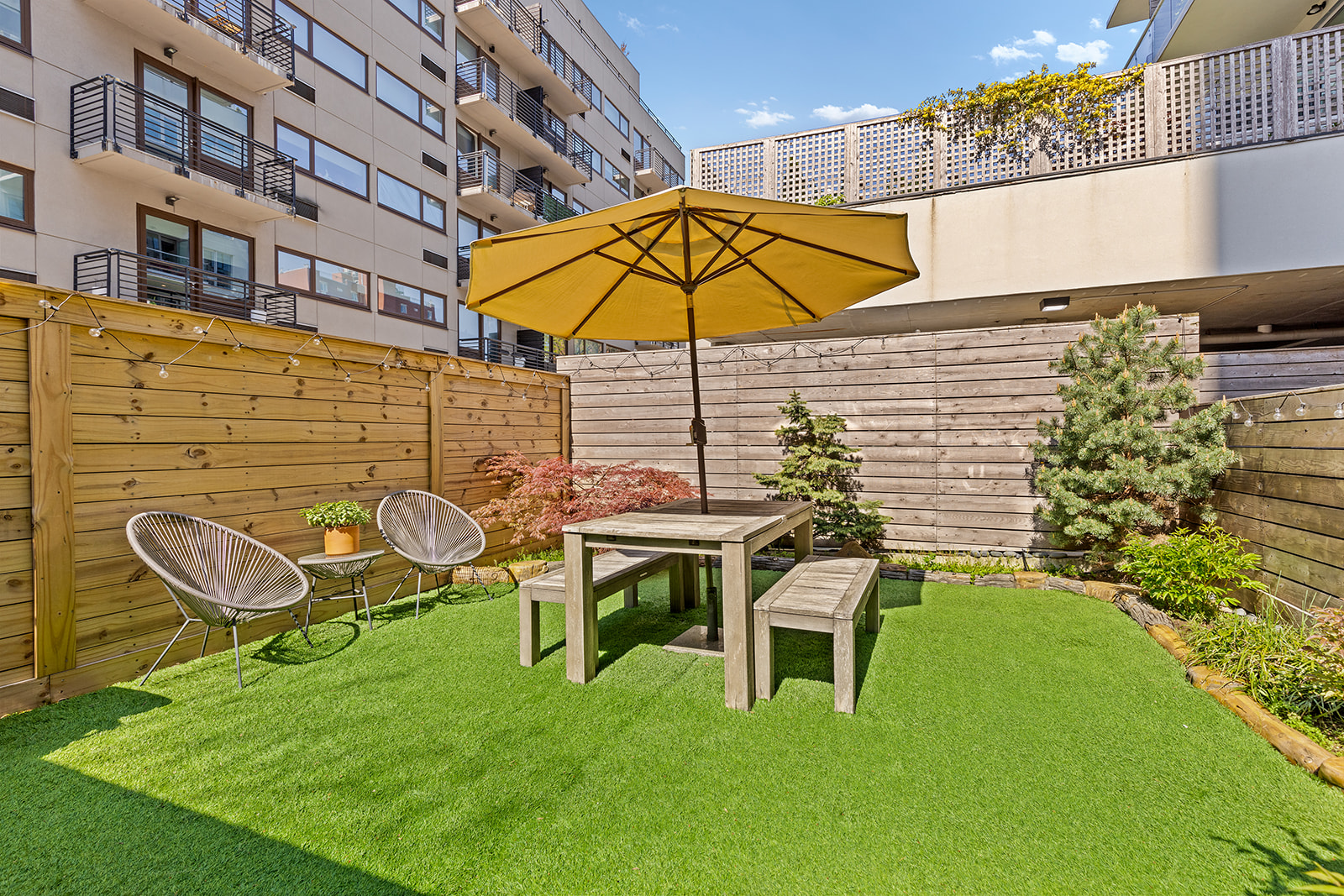 a backyard of a house with table and chairs