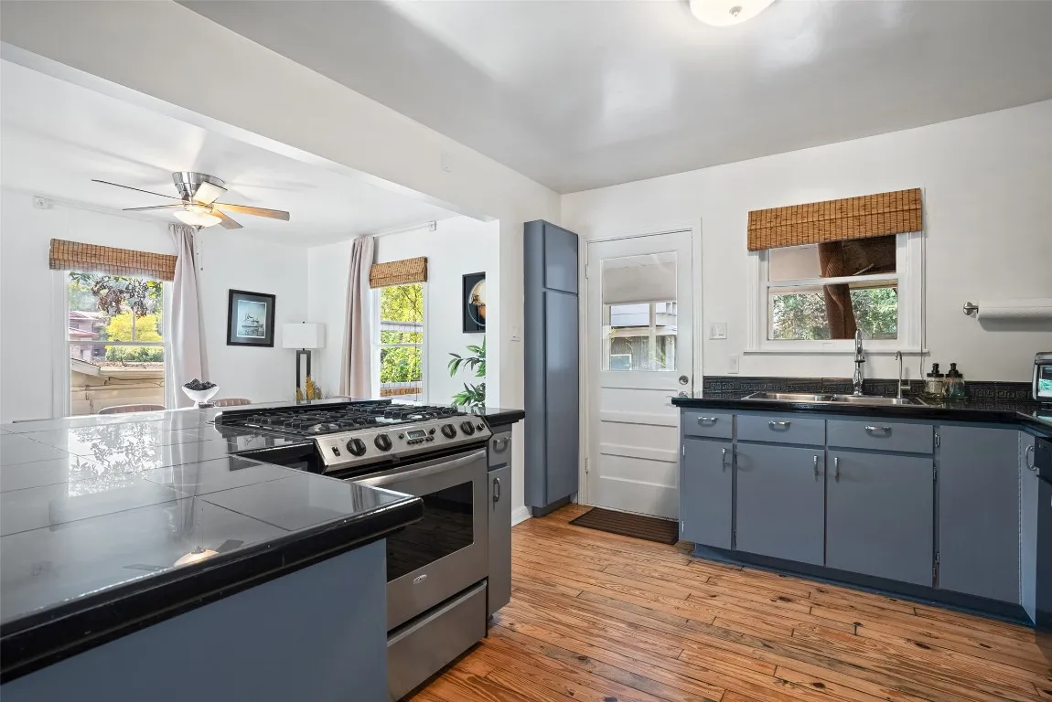 a kitchen with stainless steel appliances granite countertop a stove and a sink