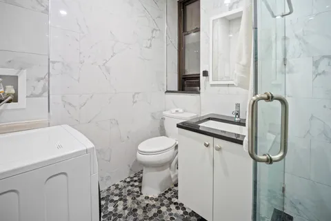 a bathroom with a sink toilet and shower