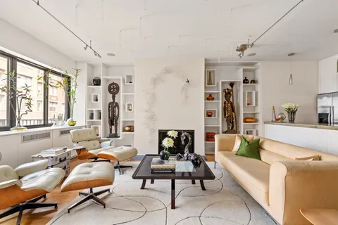 a living room with furniture and large windows