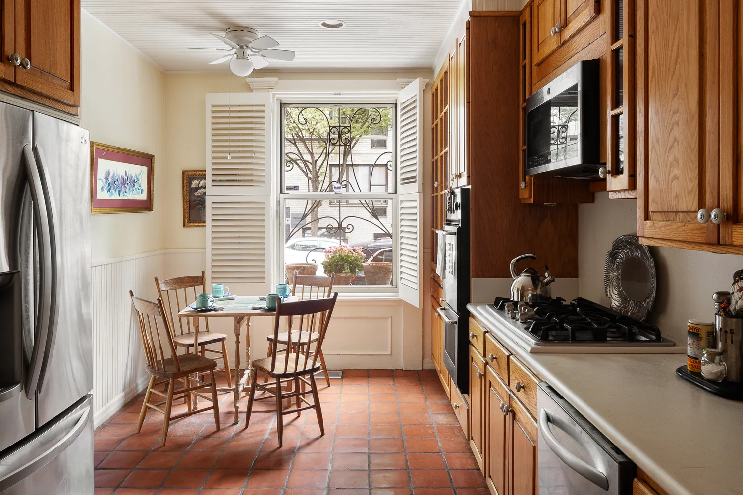 a kitchen with a table chairs refrigerator and cabinets