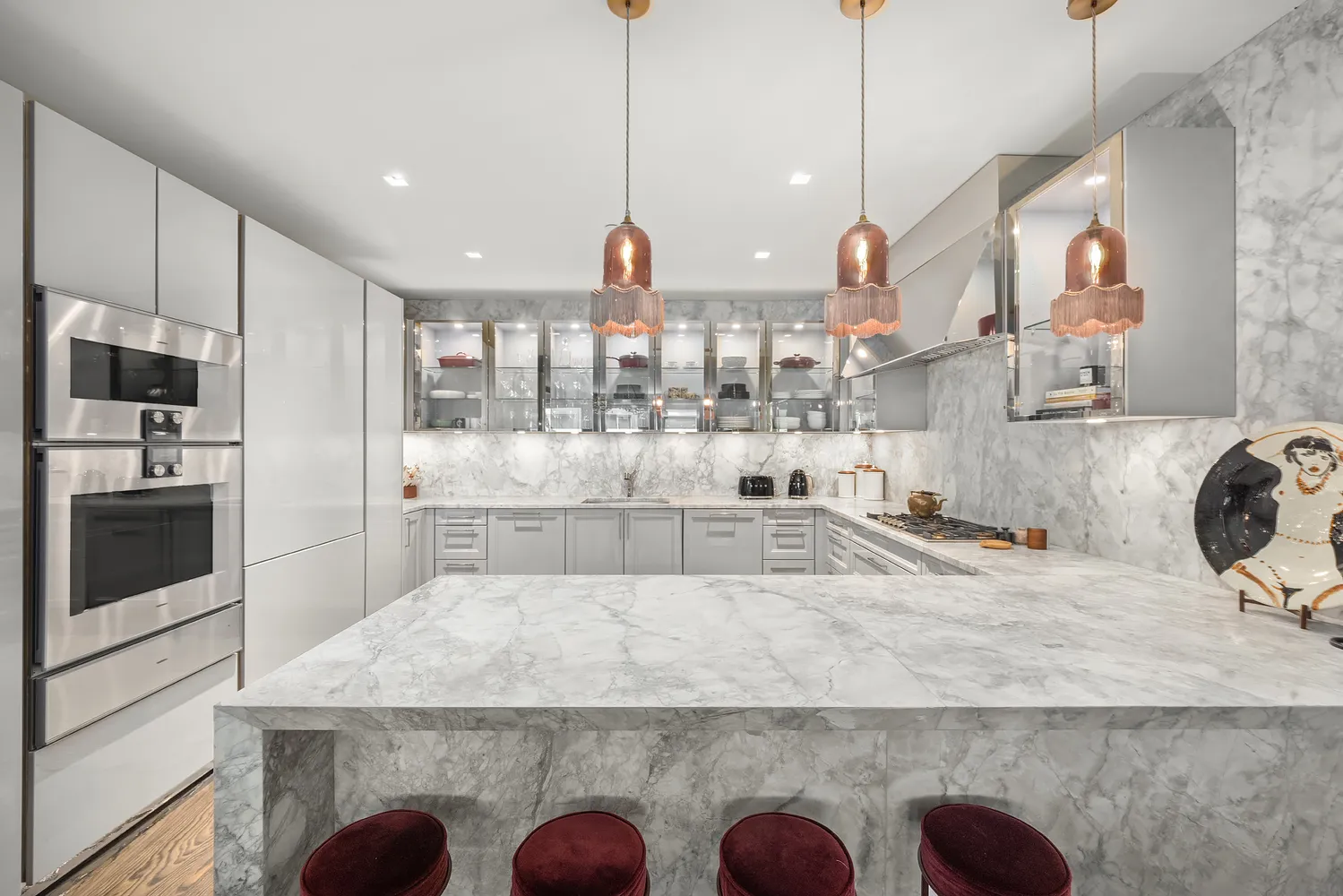 a large kitchen with kitchen island granite countertop a sink a counter space stainless steel appliances and cabinets