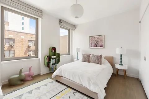 a bedroom with bed and a large window