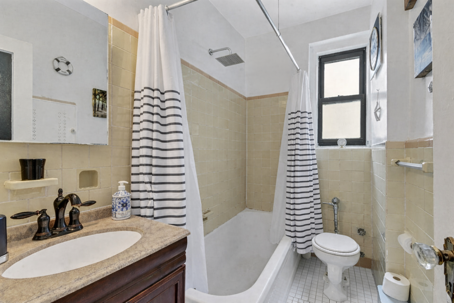 350 Cabrini Boulevard, Unit 6N Manhattan, NY 10040 - Photo 8 of 9 a bathroom with a granite countertop toilet sink and mirror