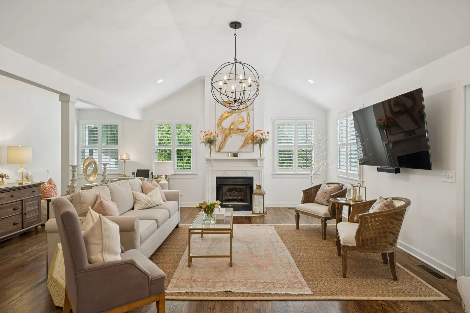 a living room with furniture chandelier and a table