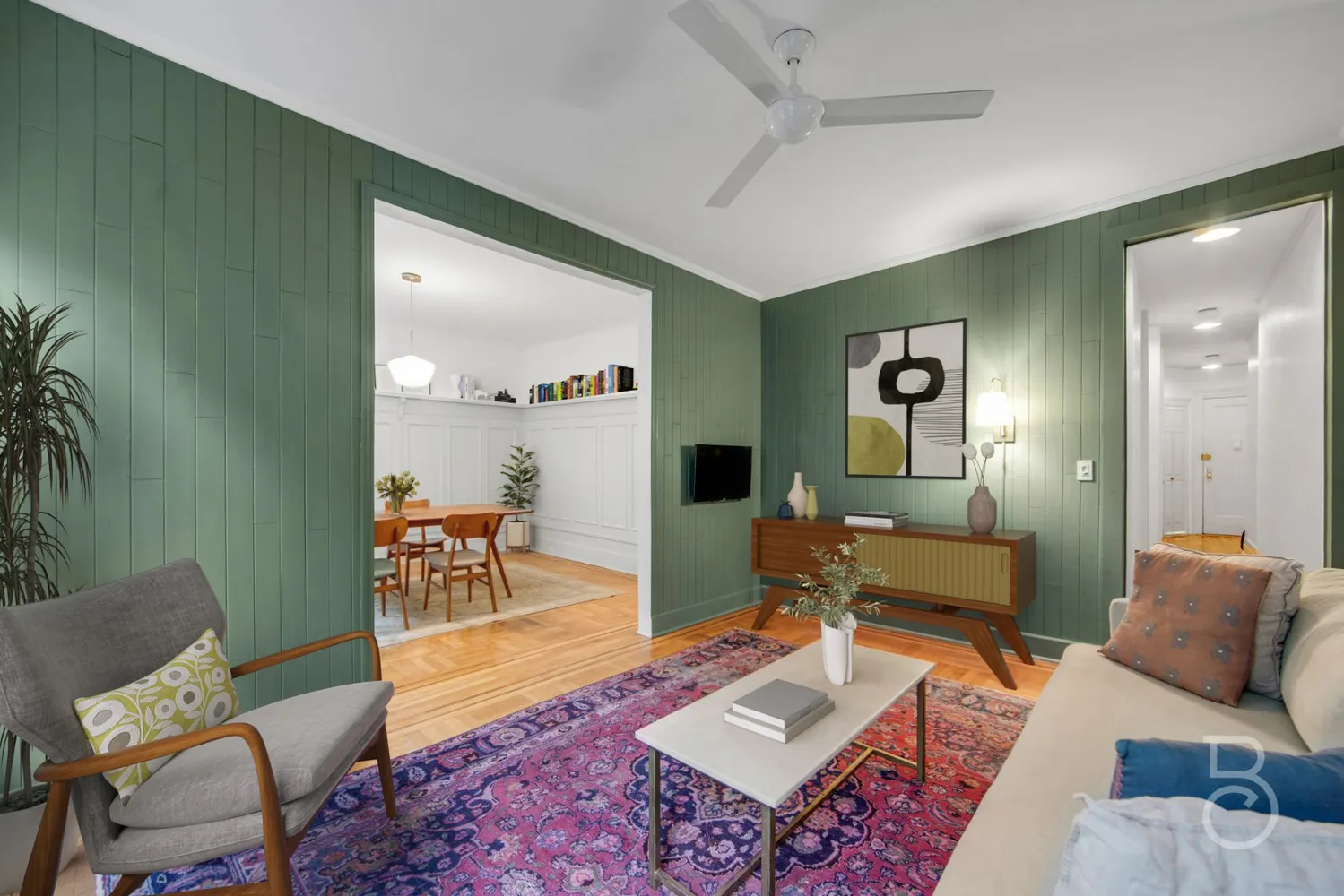 a living room with furniture and wooden floor