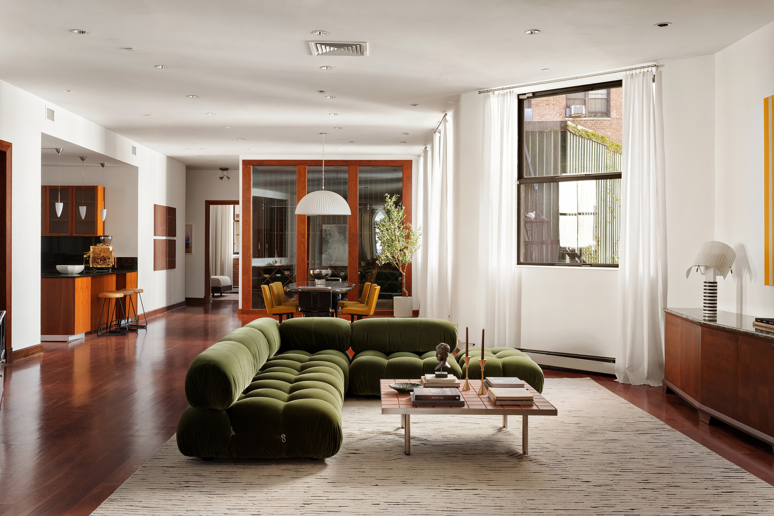 a living room with furniture and wooden floor