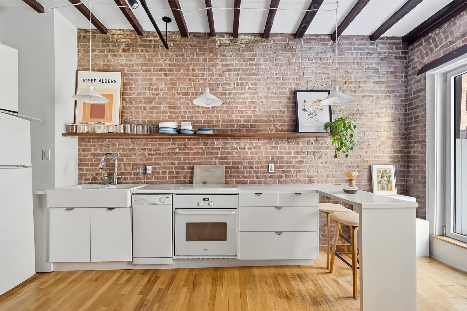 a view of a kitchen with a sink a stove top oven and cabinetry