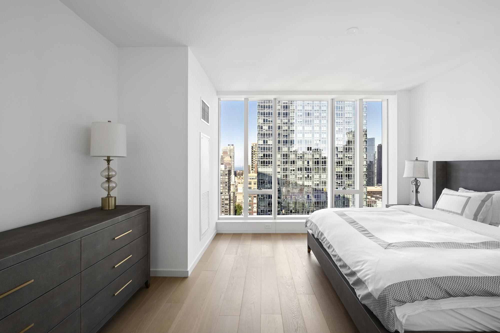 1 West End Avenue, Unit 26G Manhattan, NY 10023 - Photo 11 of 33 a bedroom with a bed and a large window