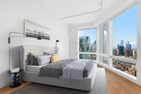 a bedroom with a large bed and a large window