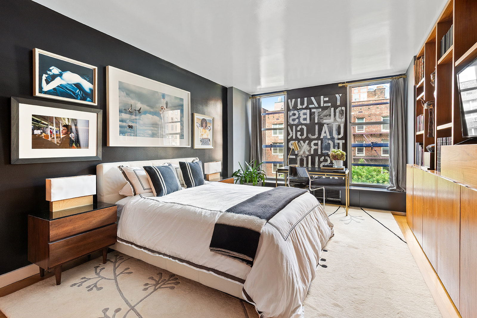 37 West 12th Street, Unit 6G Manhattan, NY 10011 - Photo 9 of 17 a bedroom with a bed a couch and a large window