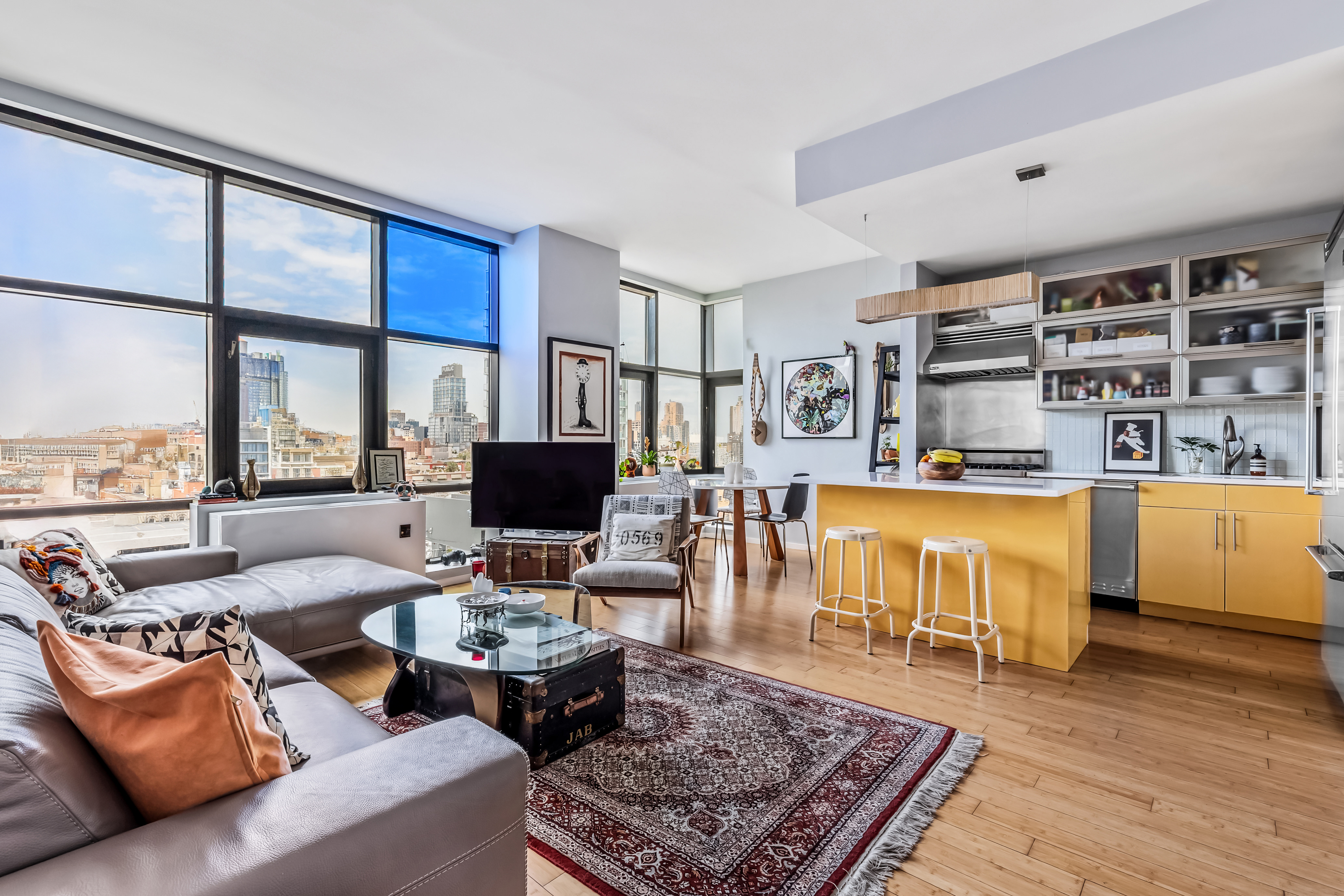 105 Norfolk Street, Unit 10A Manhattan, NY 10002 - Photo 1 of 11 a living room with furniture wooden floor and a large window