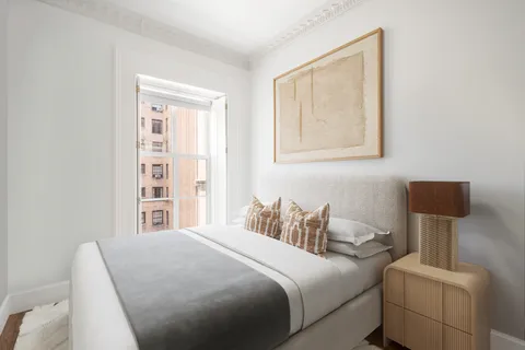 a bedroom with a bed and a night stand