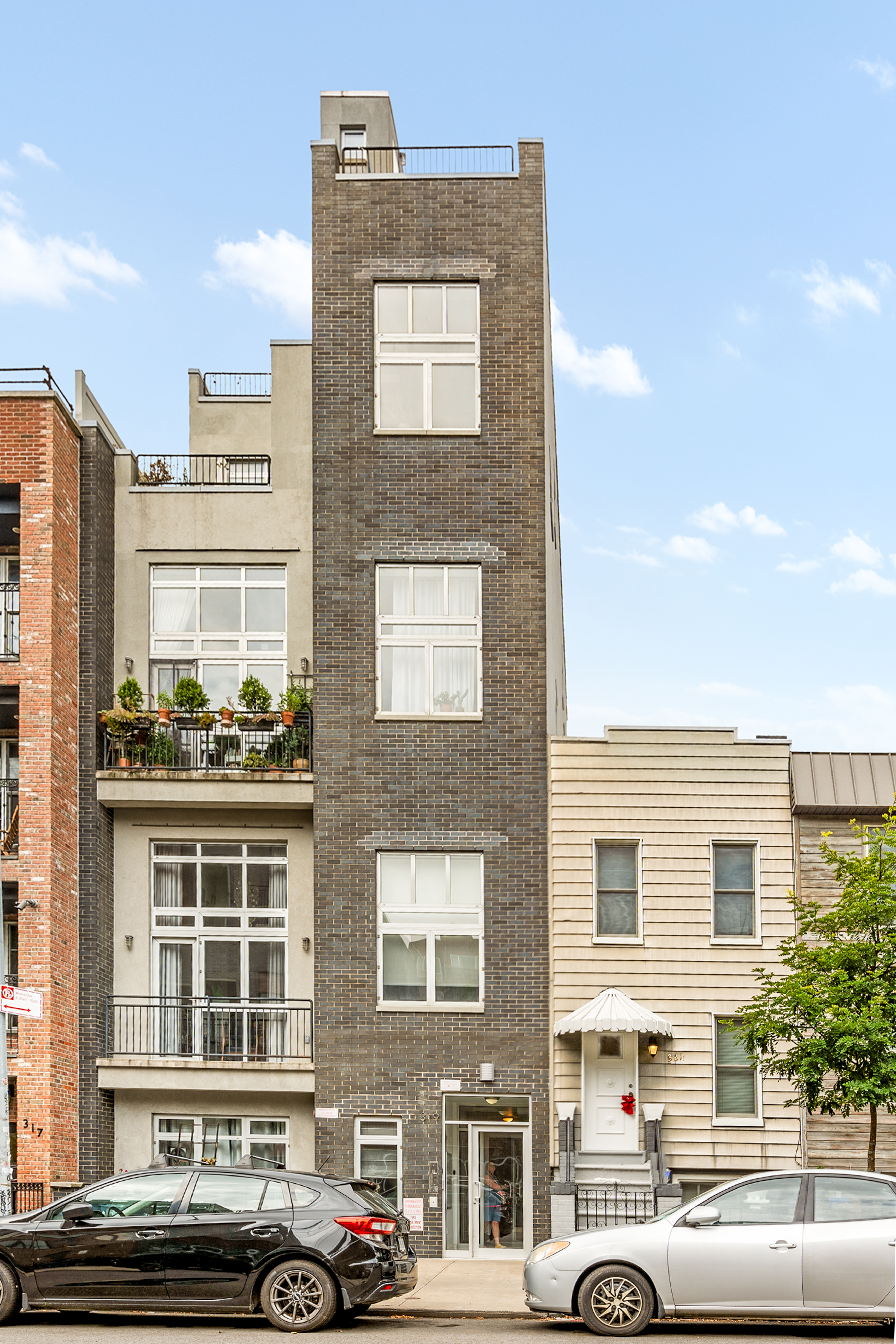 319 Humboldt Street, Unit 1A Brooklyn, NY 11211 - Photo 7 of 10 a front view of a building with parking space