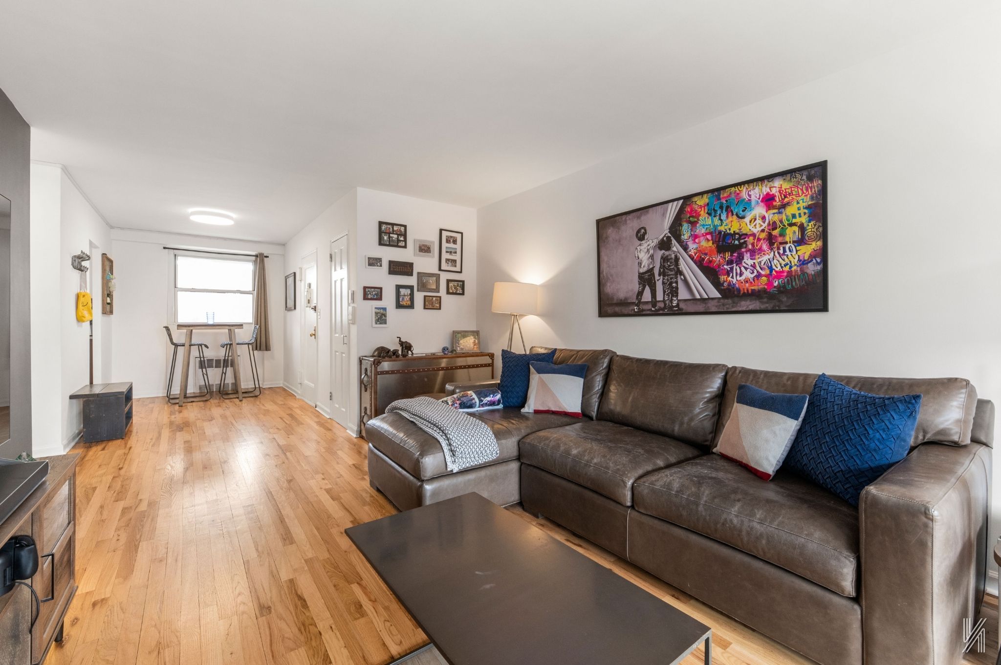 35-50 85th Street, Unit 7H Queens, NY 11372 - Photo 3 of 16 a living room with furniture and a wooden floor