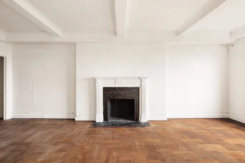 a view of an empty room with a fireplace
