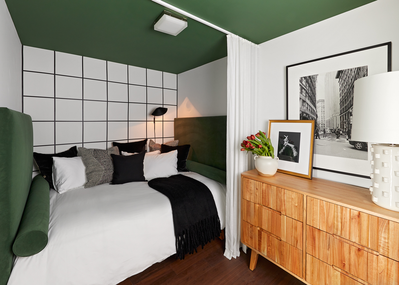 120 Nassau Street, Unit 24B Brooklyn, NY 11201 - Photo 3 of 10 a bed room with a bed and a flat tv screen on a dresser