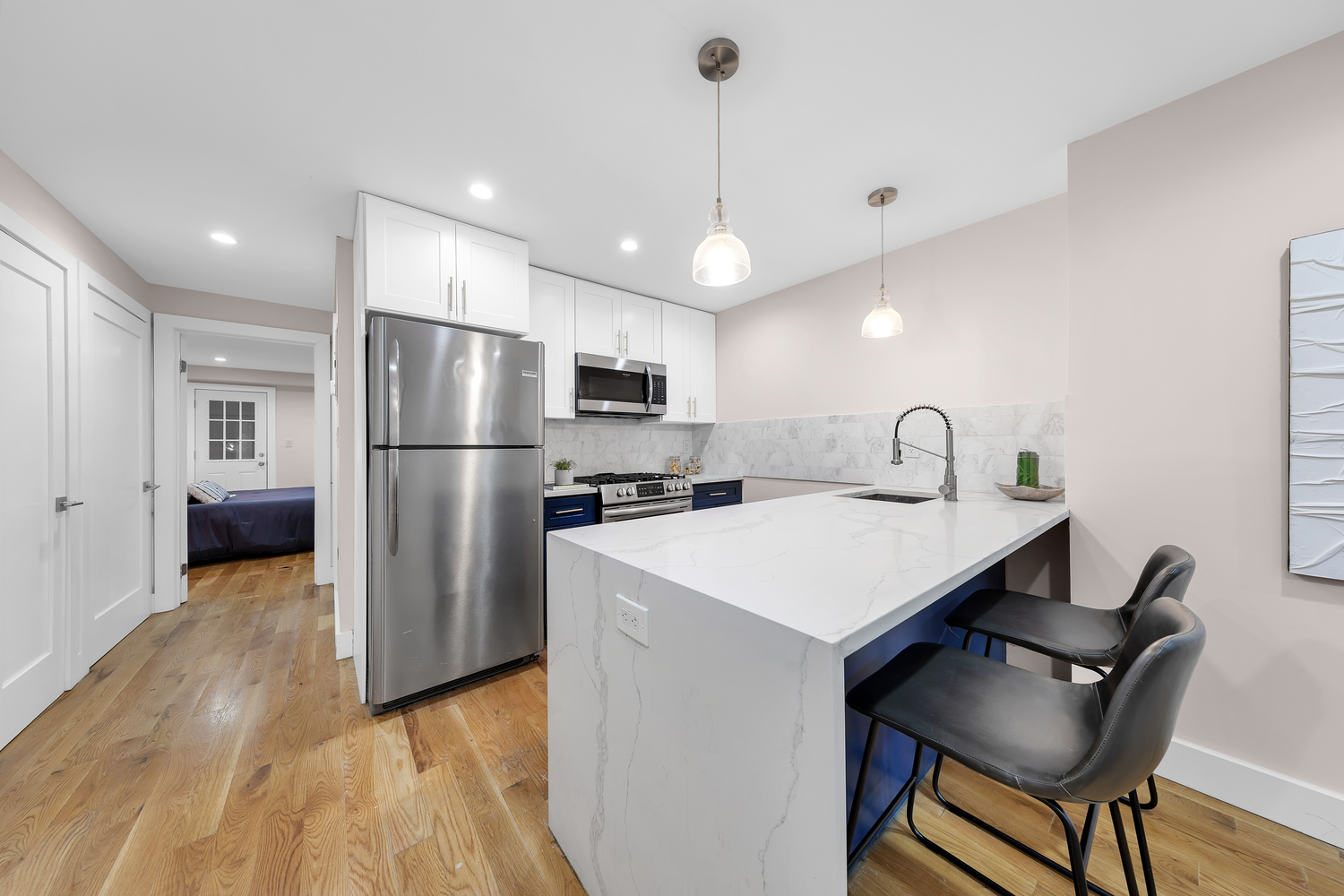 1118 Decatur Street Brooklyn, NY 11207 - Photo 13 of 18 a kitchen with refrigerator and chairs