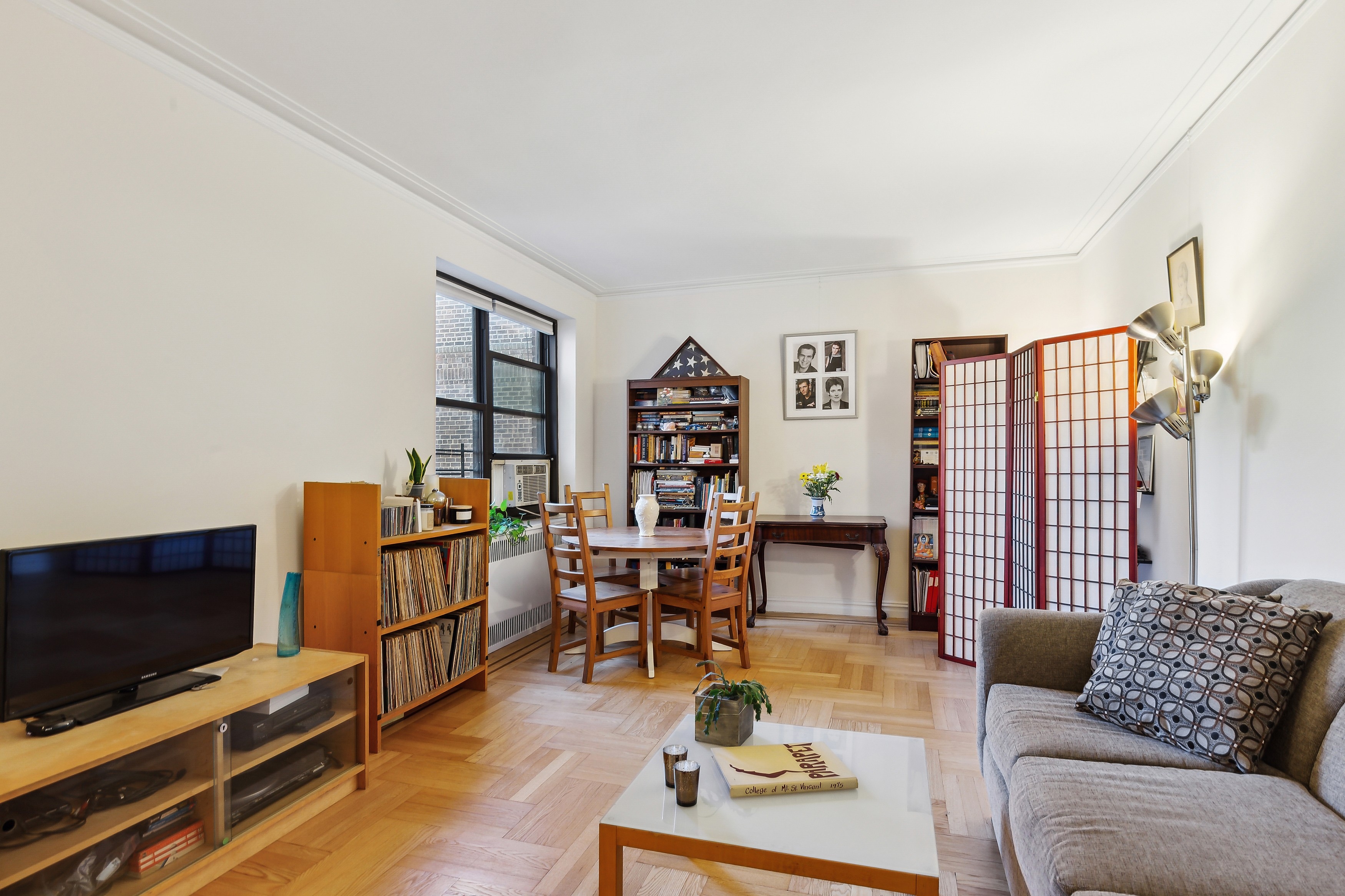 50 Park Terrace East, Unit 7E Manhattan, NY 10034 - Photo 2 of 19 a living room with furniture and a flat screen tv