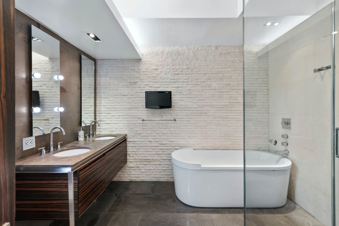 405 Broadway, Unit 4 Manhattan, NY 10013 - Photo 11 of 19 a bathroom with a bathtub and double sink