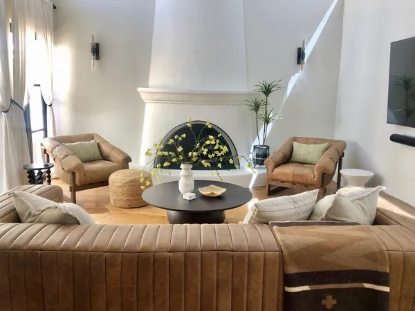 a living room with furniture and a fireplace