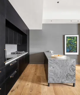 a kitchen with granite countertop a stove and a sink