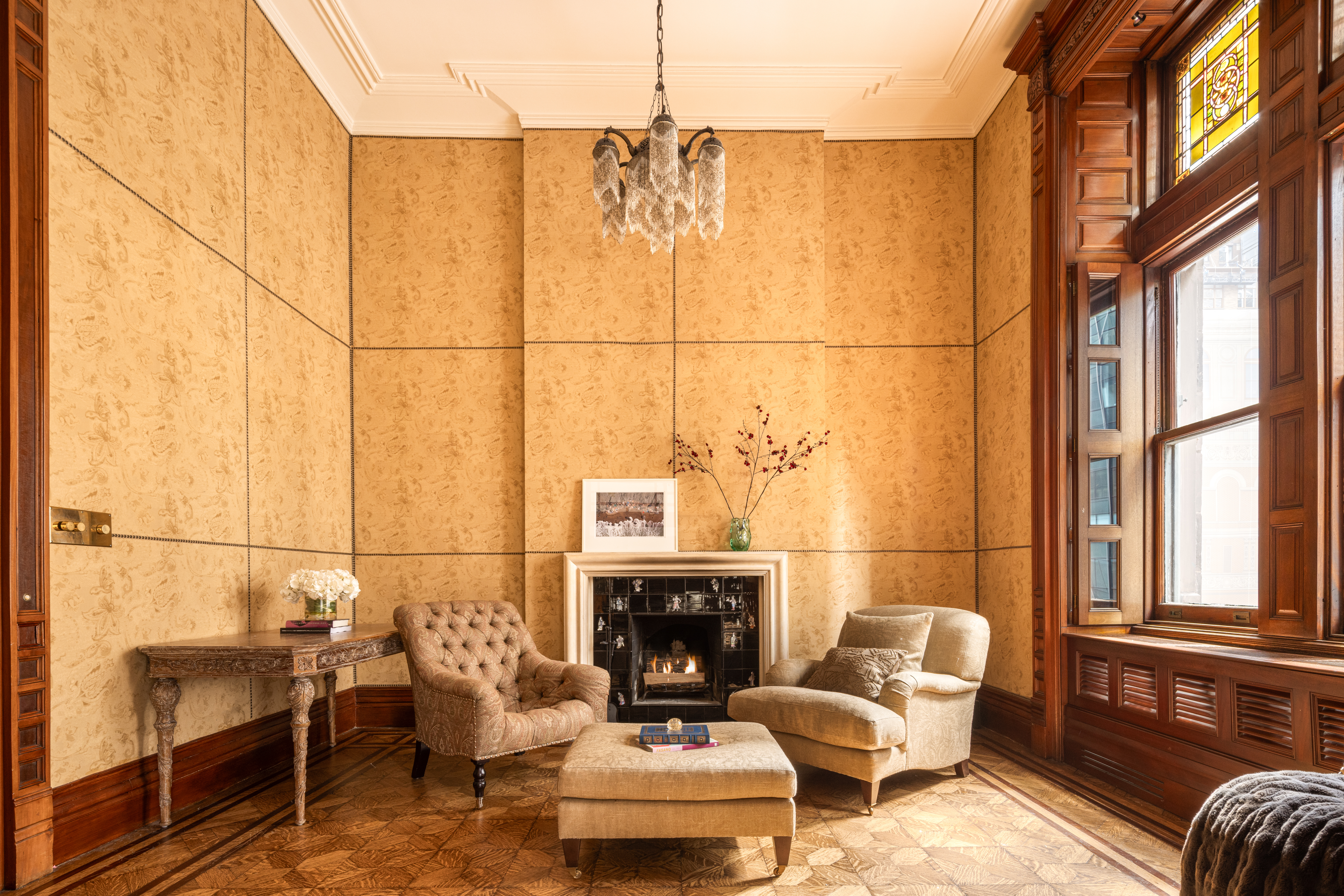 205 West 57th Street, Unit 4B Manhattan, NY 10019 - Photo 5 of 14 a living room with furniture a fireplace and a floor to ceiling window