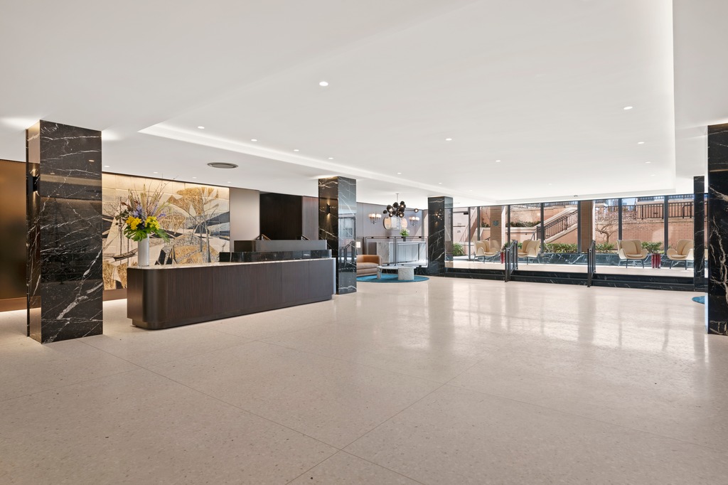 25 Sutton Place South, Unit 18M Manhattan, NY 10022 - Photo 10 of 11 a view of a living room and a flat screen tv