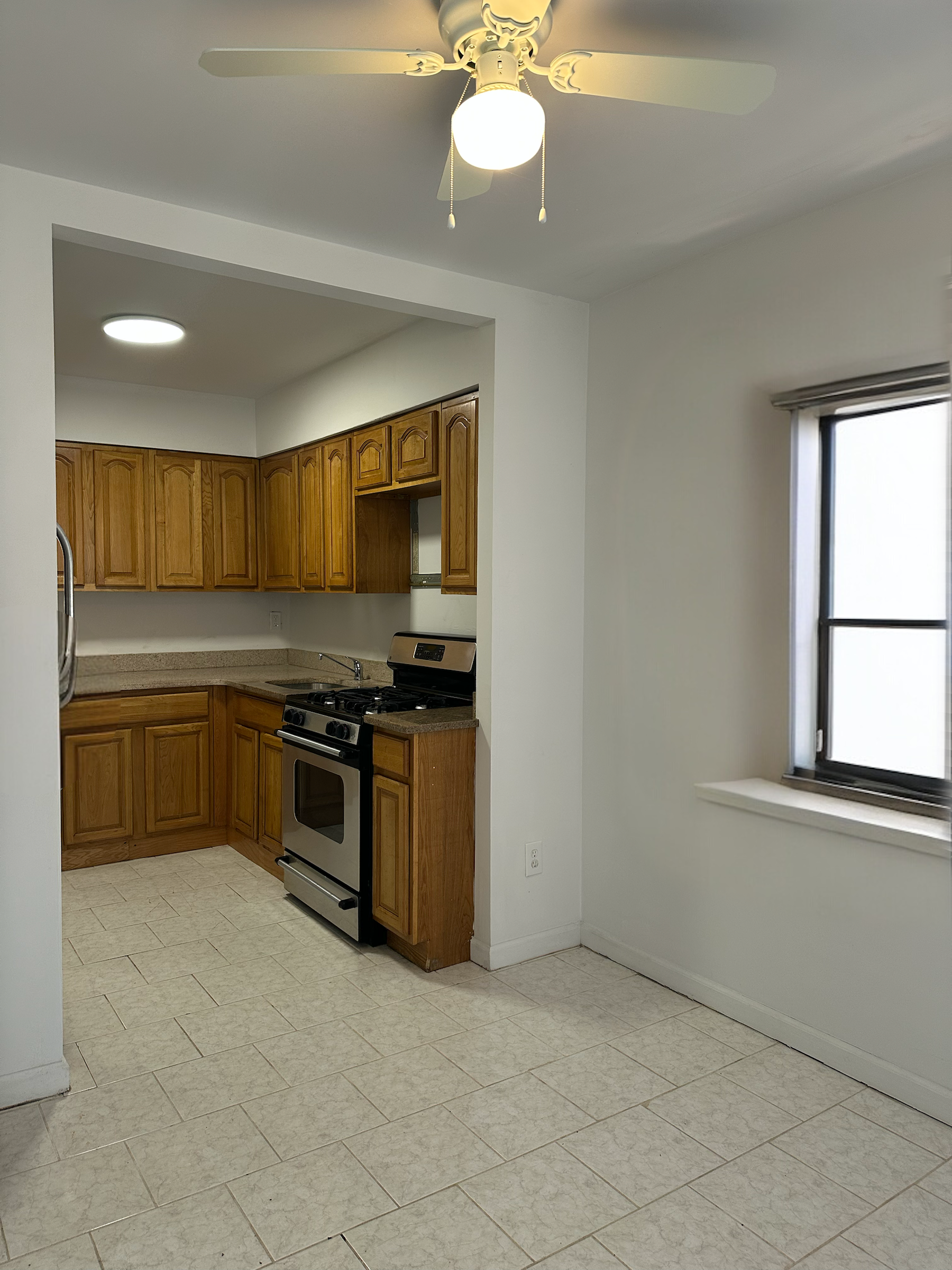 9823 Seaview Avenue, Unit 1 Brooklyn, NY 11236 - Photo 1 of 3 a kitchen with a sink cabinets and stainless steel appliances