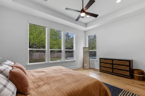 a bedroom with a bed and a large window