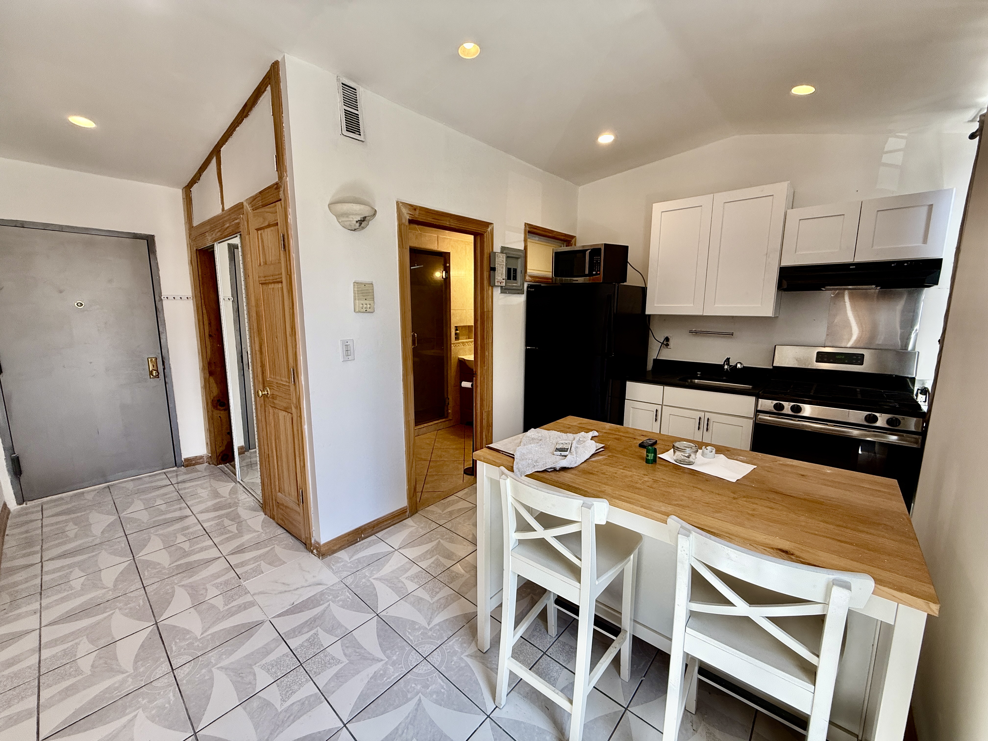 295 Greene Avenue, Unit 2 Brooklyn, NY 11238 - Photo 5 of 6 a kitchen with stainless steel appliances granite countertop a refrigerator and a stove top oven