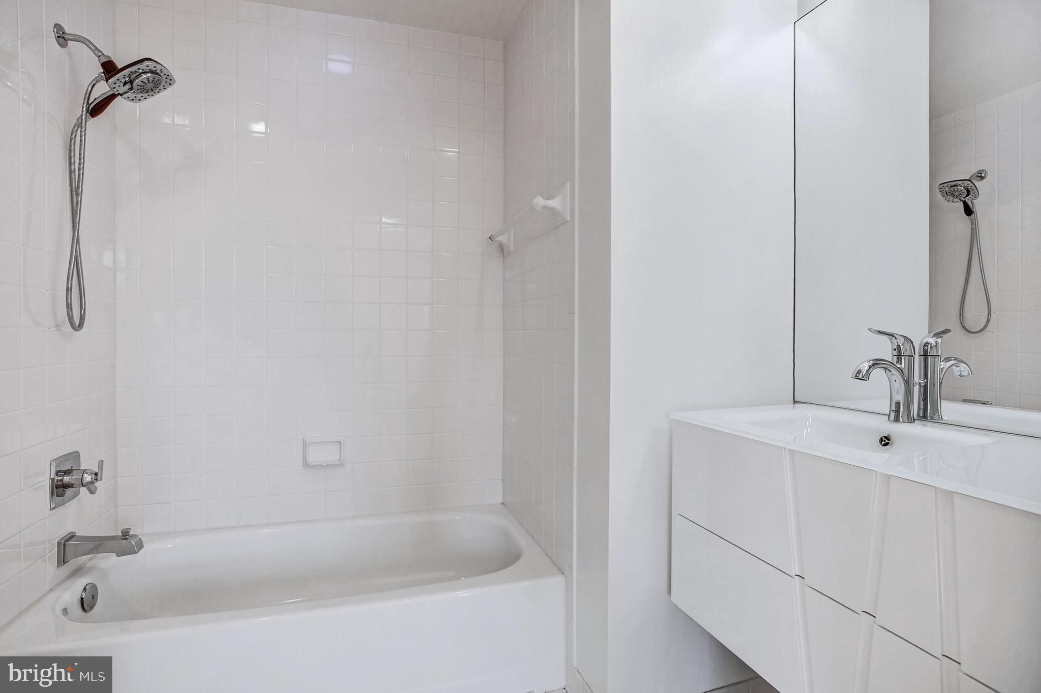 4709 Foxhall Crescent Northwest Washington, DC 20007 - Photo 45 of 57 a bathroom with a bathtub