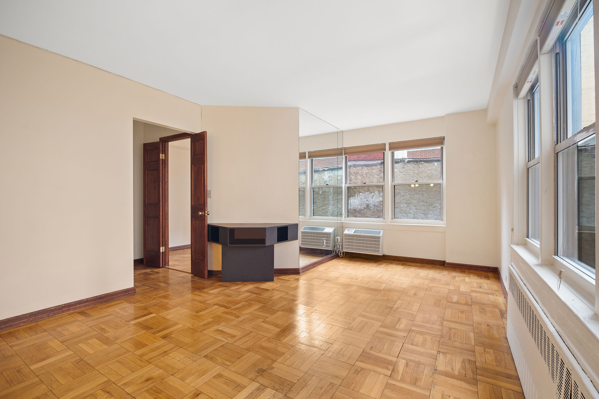 155 East 38th Street, Unit 5L Manhattan, NY 10016 - Photo 2 of 9 an empty room with windows