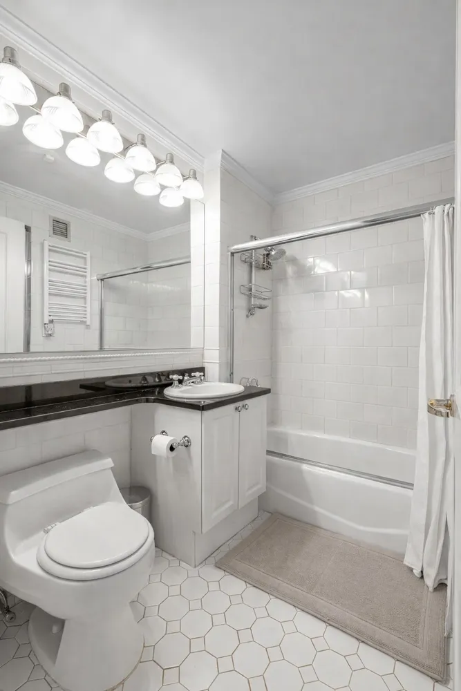 a bathroom with a sink a toilet and bathtub