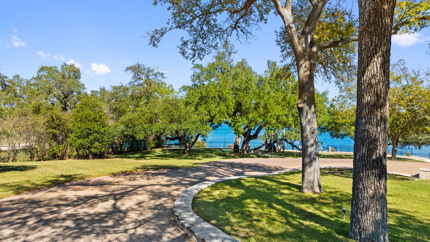 an aerial view of a house with a yard and lake view