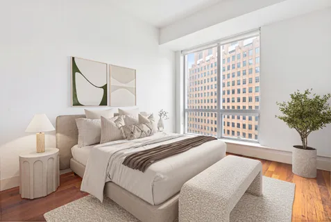 a bedroom with bed and a large window
