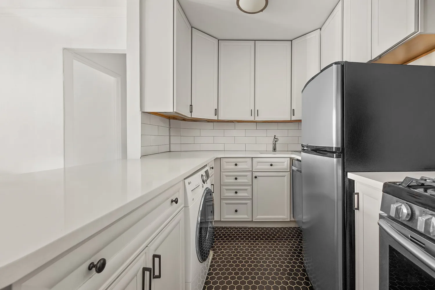a kitchen with stainless steel appliances a refrigerator stove and cabinets