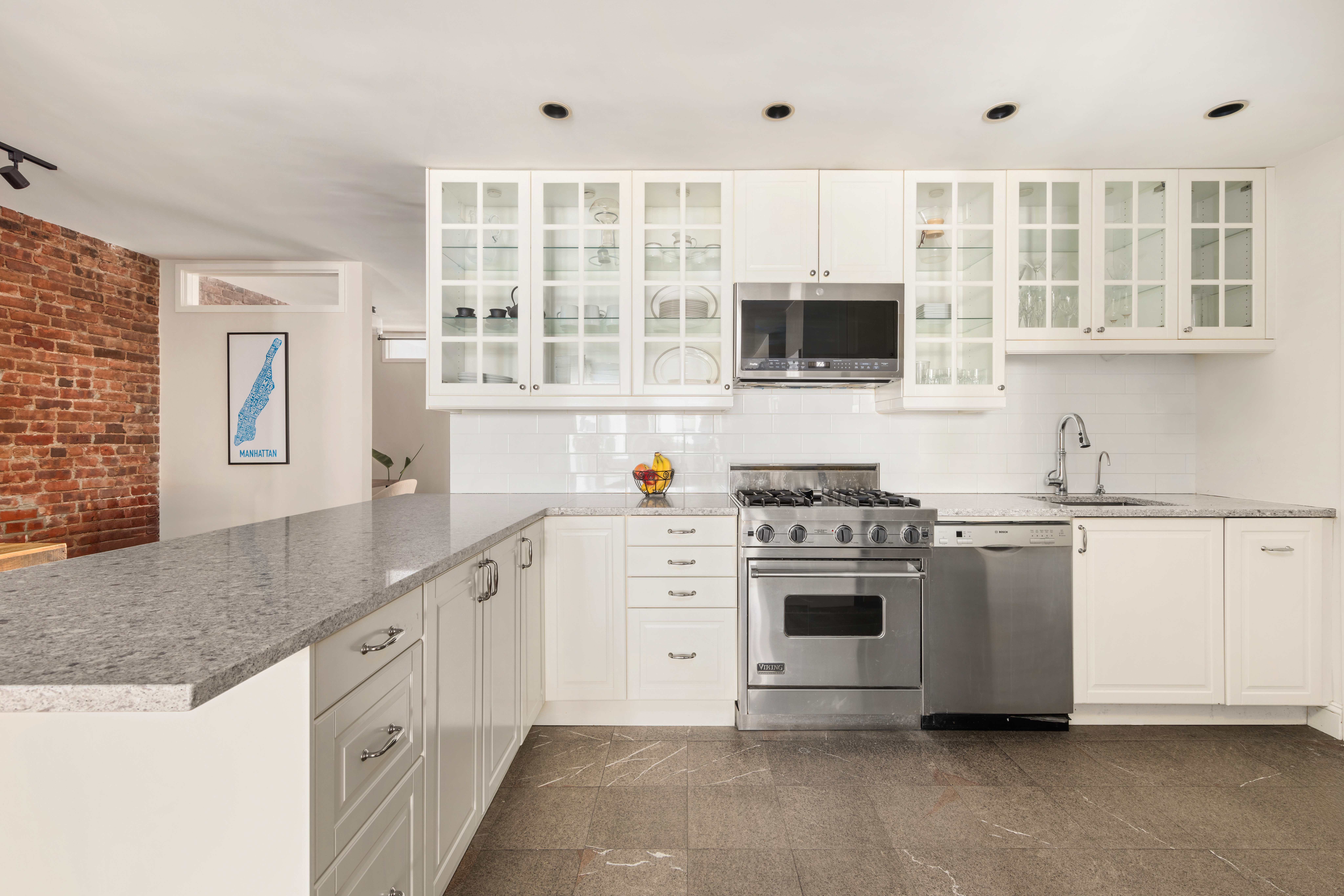 99 Reade Street, Unit 5E Manhattan, NY 10013 - Photo 4 of 13 a kitchen with stainless steel appliances granite countertop a stove and a sink