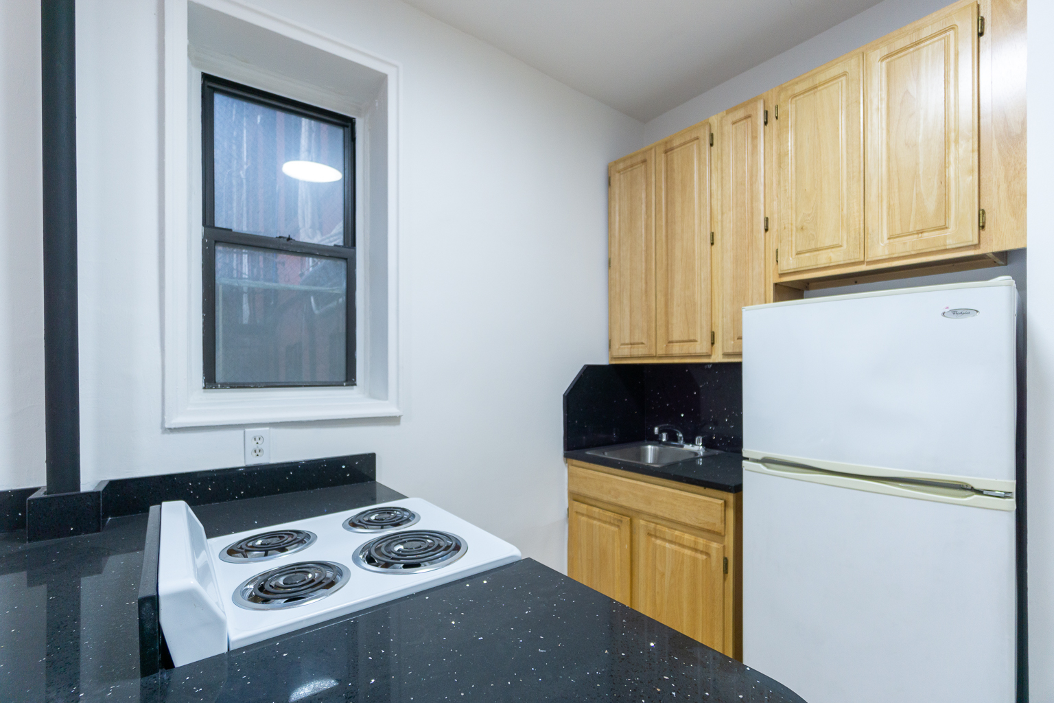 315 East 5th Street, Unit 1C Manhattan, NY 10003 - Photo 13 of 15 a kitchen with a refrigerator and a stove top oven