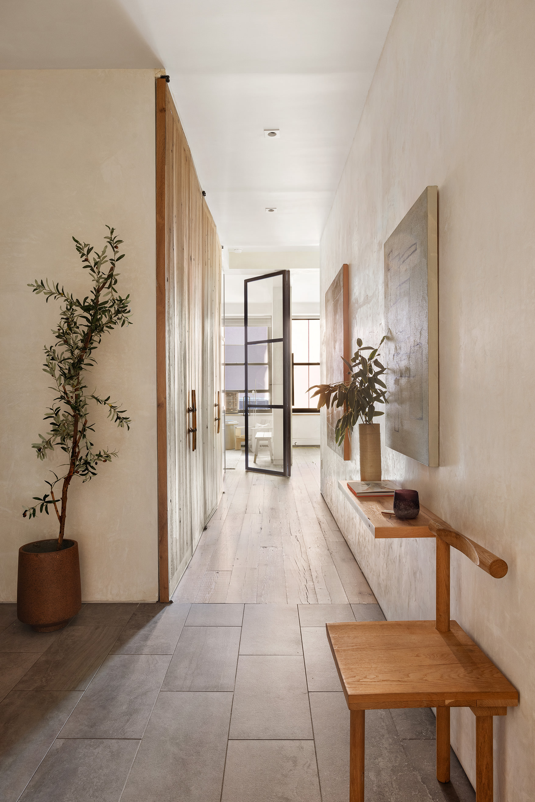250 Mercer Street, Unit B706B707 Manhattan, NY 10012 - Photo 7 of 25 a hallway with a table and a potted plant