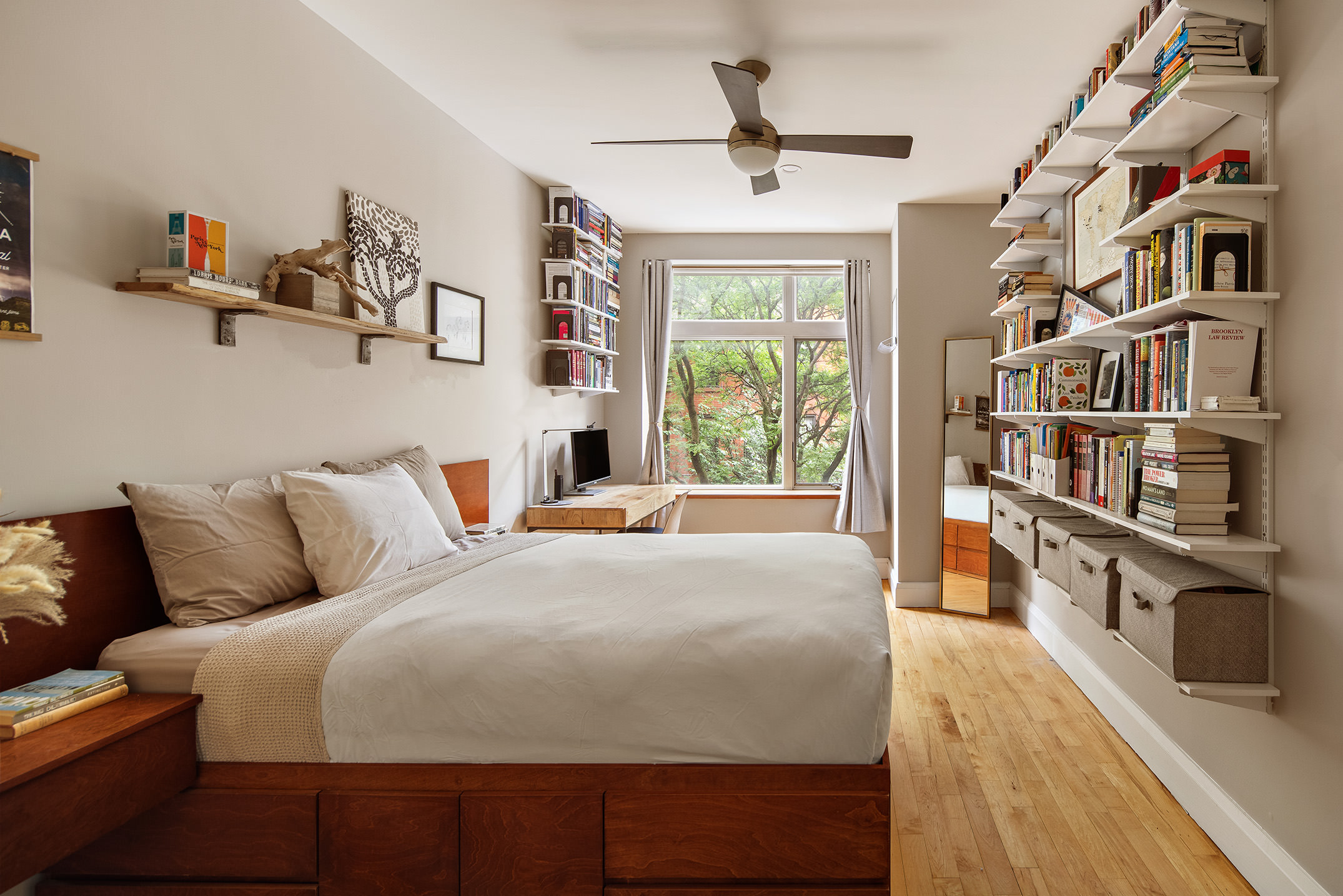 675 Sackett Street, Unit 210 Brooklyn, NY 11217 - Photo 3 of 8 a bed room with a bed and a book shelf