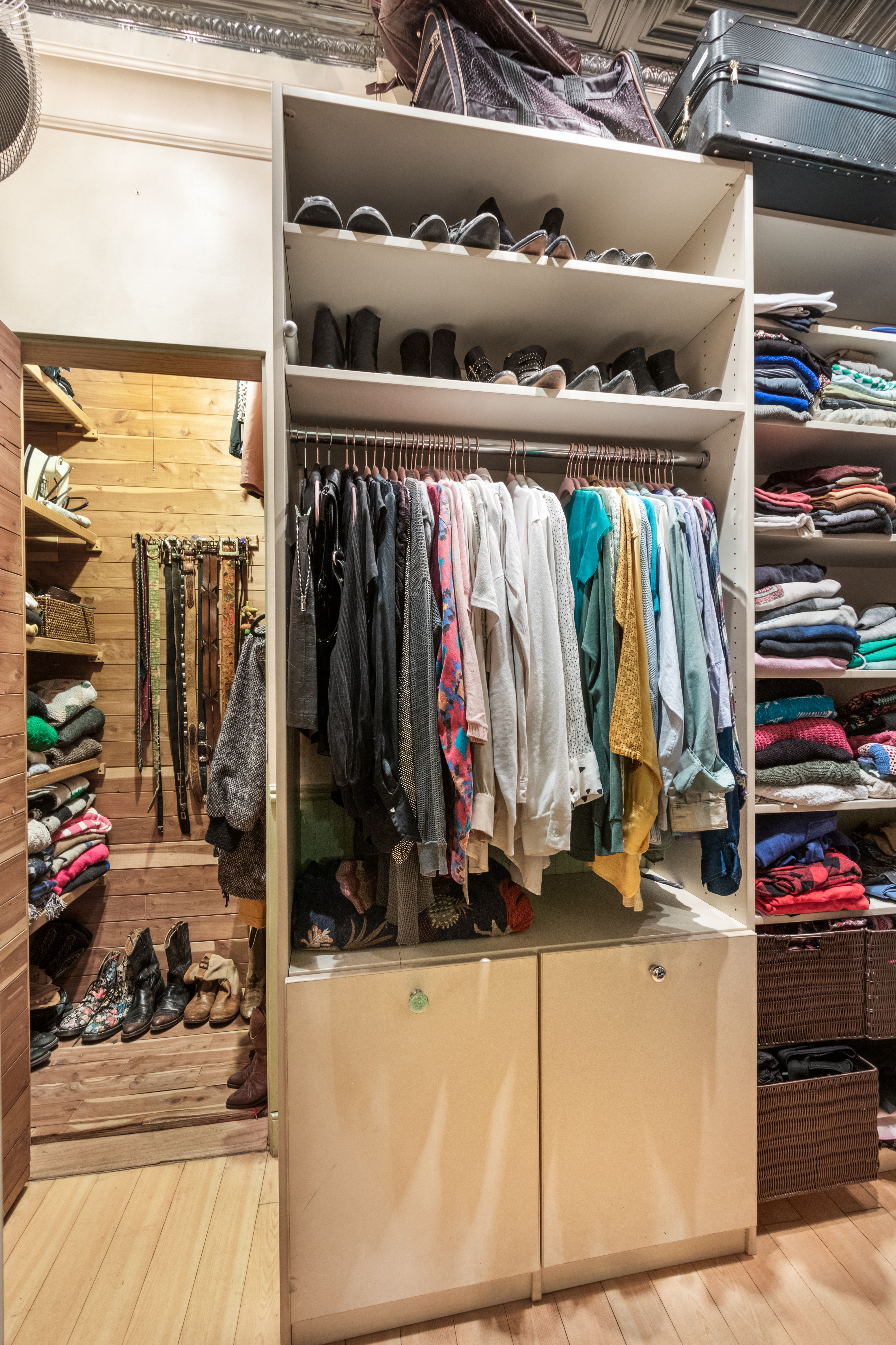324 Pearl Street, Unit 1F Manhattan, NY 10038 - Photo 5 of 12 a view of walk in closet with clothes and shoes