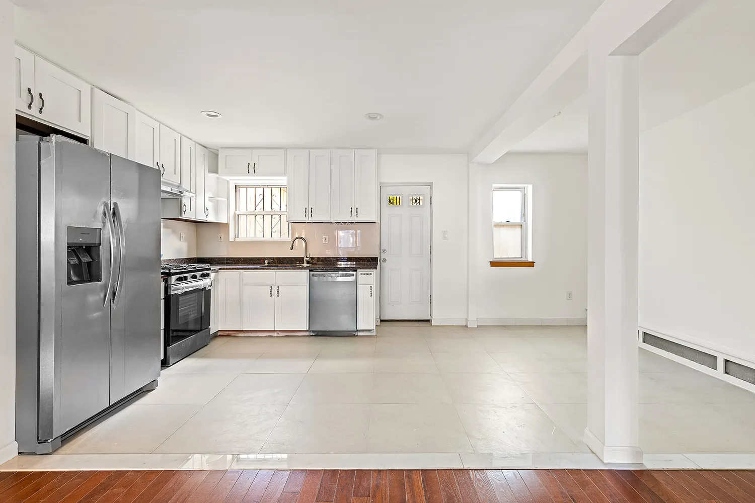 a kitchen with stainless steel appliances a refrigerator sink and cabinets