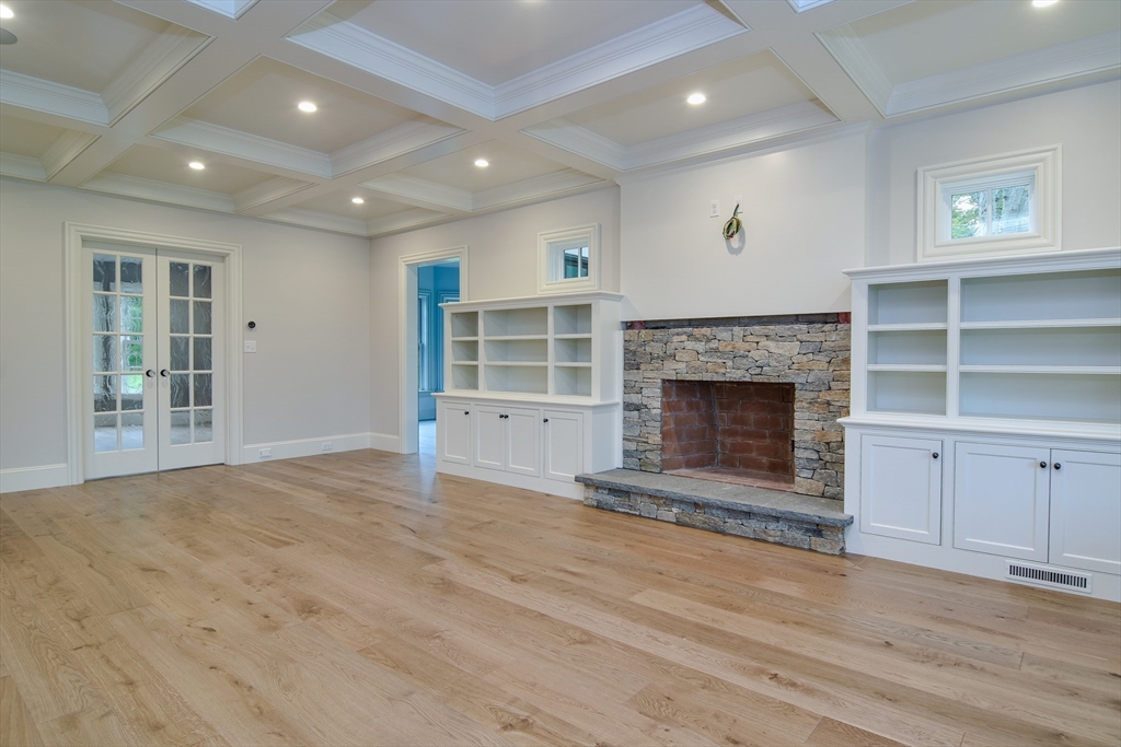185 Dedham Street Dover, MA 02030 - Photo 9 of 32 an empty room with a fireplace and window