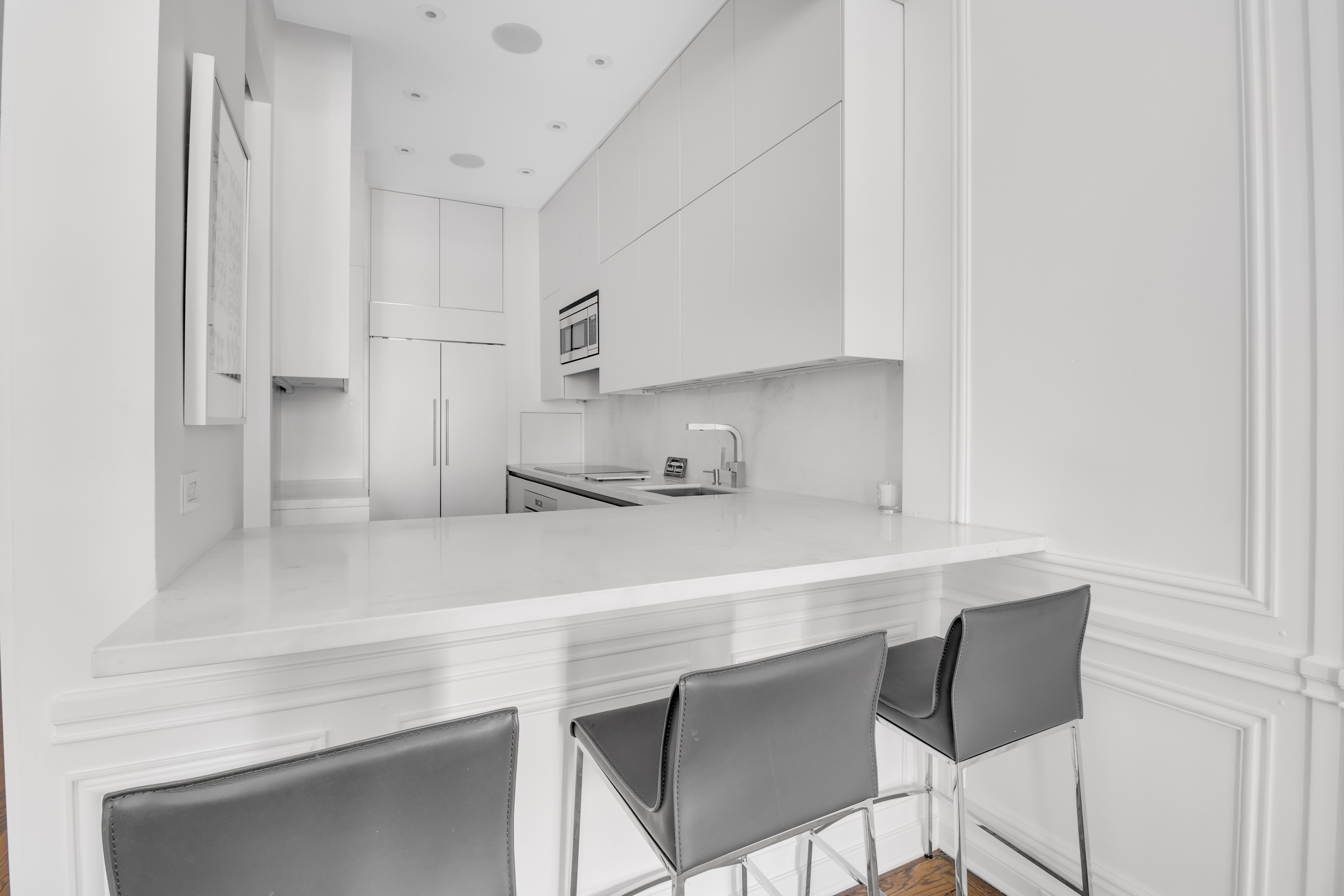 14 East 68th Street, Unit 3 Manhattan, NY 10065 - Photo 7 of 16 a kitchen with a sink cabinets and wooden floor